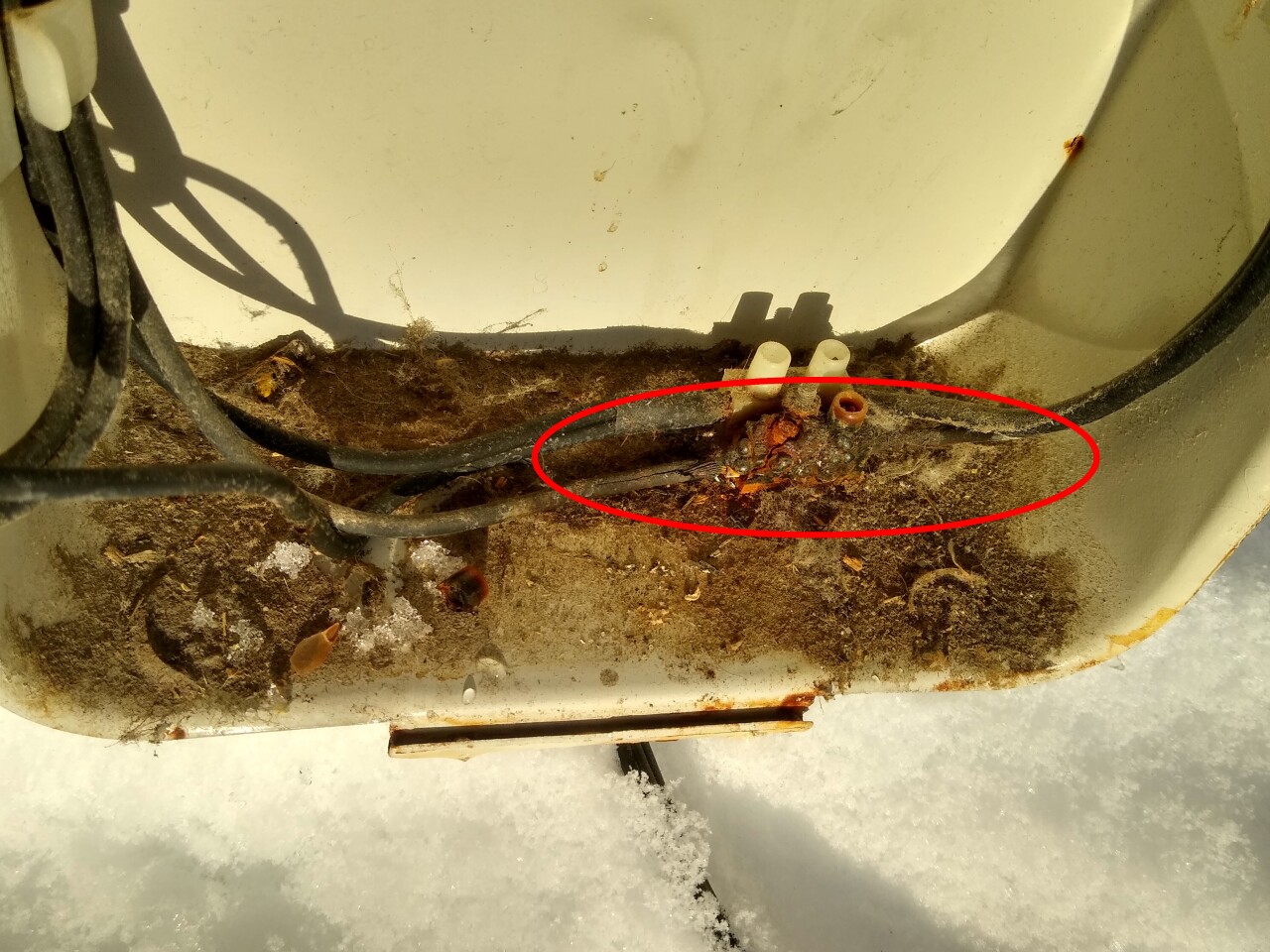 A dangerous Delonghi electric heater with melted and exposed wiring around an overheated junction. This heater has been permanently removed from use.